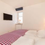 Schlafzimmer mit Bett, TV und Fenster
