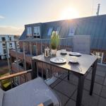 Terrasse mit Tisch, Stühlen und Blick auf Gebäude