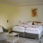 Zimmer mit Doppelbett, Sessel und Glas-Tisch