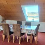 Esszimmer mit Sitzgruppe, Fenster und Holzdecke