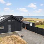 Black holiday home with sea view and garden