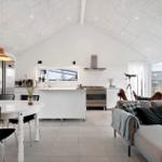 Living and dining area with kitchen island and large window access.