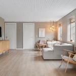 Living room with sofa, chair, and TV on wall