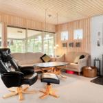 Living room with seating group, wood stove, and large window area.
