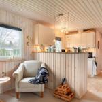 Living area with seating, kitchenette, and view of the outside.