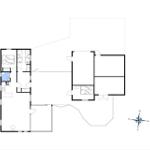 Functional floor plan with kitchen, bedrooms, and bathroom. Orientation with compass.