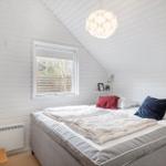 Bedroom with bed, window, and ceiling light.
