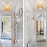 Hallway with white walls, wooden floor, and round ceiling lights.