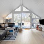 Living room with sofa, fireplace, and glass door to terrace.