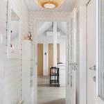 Hallway with white walls, wooden floor, and a round ceiling lamp.