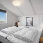Schlafzimmer mit Doppelbett, Fenster und Wandbild.
