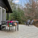 Deck with table, chairs, and view into the forest