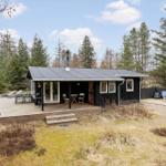 Black cabin with deck and garden. Grill and seating available.