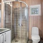 Bathroom with shower, toilet, and sink.