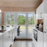 Modern kitchen with white cabinets and view of terrace