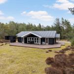 Modern wooden cabin with terrace in forest area