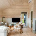 Living room with wooden walls, fireplace, and sofa with fur throw.