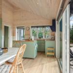 Kitchen with dining area and view of terrace with loungers.
