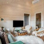 Living room with fireplace, sofa, TV, and chairs.