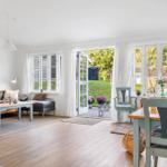 Living and dining area with terrace, windows, and hardwood floor.