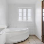 Bathroom with bathtub, sink, and shower.