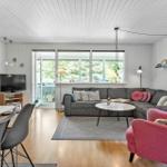 Living room with sofa, dining table, and fireplace