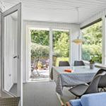 Dining room with table, chairs, and view of garden. Door leads to terrace.