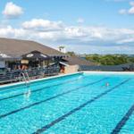 Swimming pool with view of water and landscape