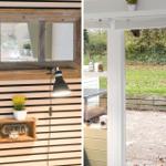 Room with wooden wall and window, view of paved courtyard with green area.