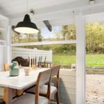 Dining area with table, chairs, and garden view through window