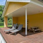 Deck with loungers, picnic table, and wooden floor under roof