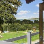 From the terrace, you can see a green garden with a playground and a lake.