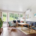 Living room with sofa, chairs, and view of garden