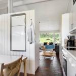 Kitchen with countertop, refrigerator, and view into living room.