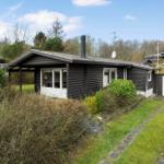 A black-clad house with white windows and a garage.