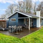 A house with a terrace, garden, and outdoor seating.