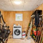 Room with washing machine, tools, and bicycle