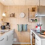 Kitchen with wooden walls, countertops, and kitchen appliances.