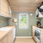 Kitchen with wooden surfaces, window, and modern equipment.