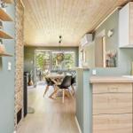 Kitchen with wooden surfaces and dining area with table and chairs.