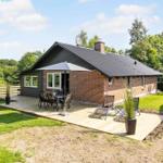 House with terrace, seating, and garden.