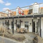 Terrace with table and chairs. Upper level with balcony and lounge chairs.