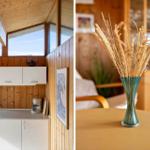 Kitchen with wooden walls and windows. Table with vase and dried grass.