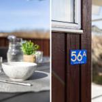 Outdoor area with table and chairs. House number 56A on the facade.