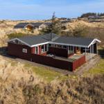 Red vacation house with terrace in dune landscape