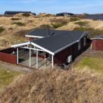 Red house with terrace and shed on dune landscape