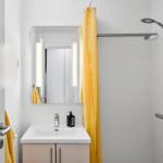 Bathroom with shower, sink, and mirror