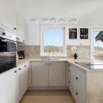 Modern kitchen with integrated oven and kitchen island.