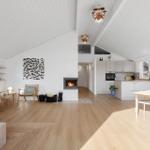 Open space with kitchen, dining area, and living area under high ceiling