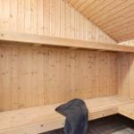 Wooden sauna with bench and heater